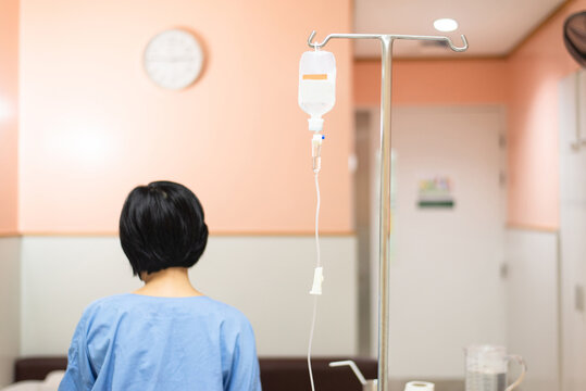 Picture of drop saline solution with blured petient in a hospital