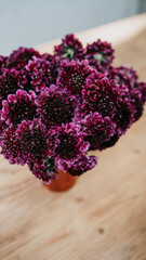 Purple flowers top view in a vase on a table