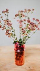 Top angle view of a vase full of flowers on a table