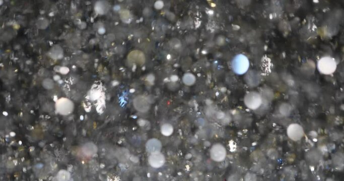 Elegant silver abstract art with flying sequins. Christmas animated gray background