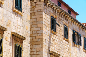 street view of the old town of Dubrovnik in Croatia, medieval European architecture, city streets, windows with wooden shutters, red tiled roofs, the concept of traveling in the Balkans