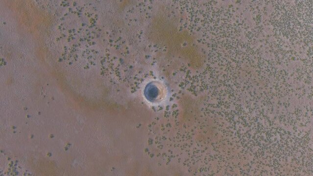 A sinkhole caused by the withdrawal of groundwater