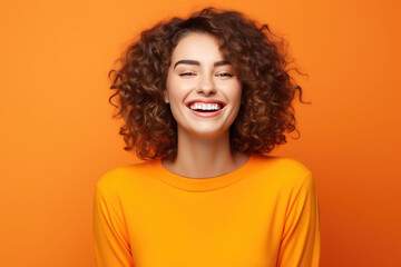 The Playful Happiness of a Woman, happy, funny and laughing. orange background