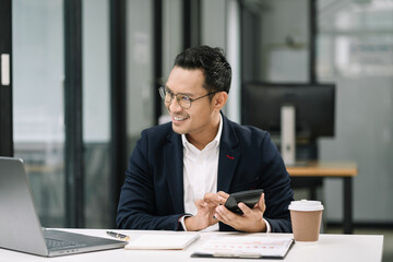 Hand businessman doing finances and calculate on desk about cost at office.