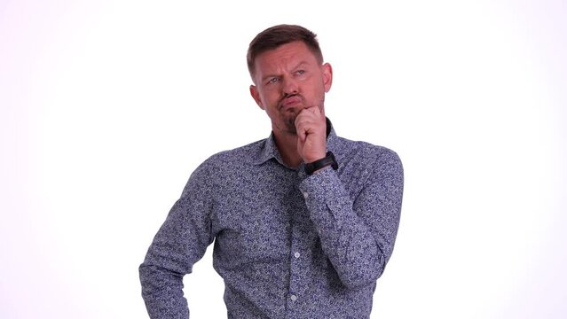 Young man is doubtful and scratching head with confused expression. Emotions of indecision doubt and decision making