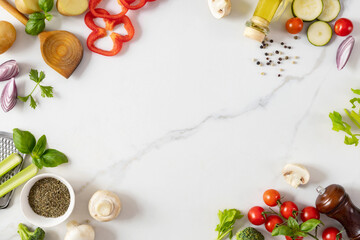 Fototapeta na wymiar Frame of healthy food cooking ingredients background with fresh vegetables, herbs, spices and olive oil on marble table top view