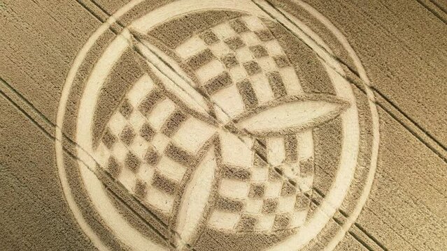 Aerial view rising over golden Hampshire unique trinity crop circle wheat field in South Wonston 2023