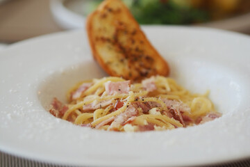 Spaghetti Carbonara, Italian Pasta with cream sauce and ham in the white plate.