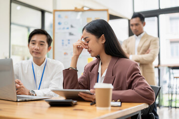 A stressed Asian businesswoman worried about her project tried to fix a project problem