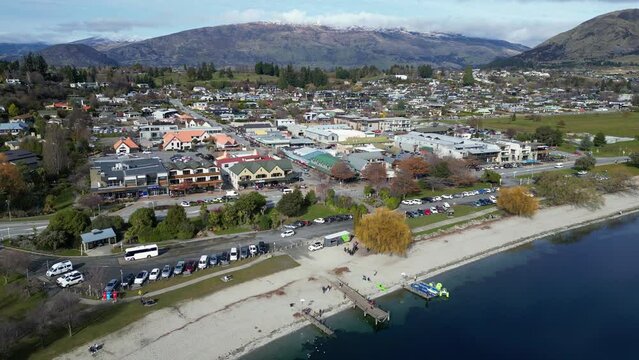 Wanaka, New Zealand: Aerial drone footage of the famous Wanaka tourist town by Lake Wanaka in Otago province in New Zealand south island in winter. Shot with a downward tilt upmotion