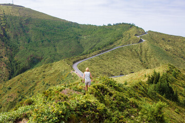 landscape in the mountains. Woman goes to the mountains