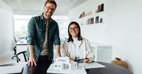 Young architects working on a house project in an office