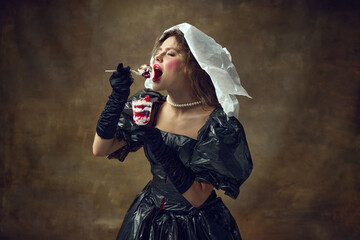Queen. Portrait of woman dressed poliethylene white cap and black dress made of garbage bags holds...