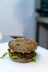 A hamburger with a flag sticking out of it. Patriotic hamburger with a flag garnish