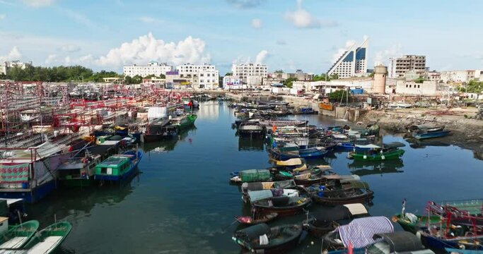The beautiful fish port wharf in Beihai, Guangxi,China, fishing boats are moored in the port under the blue sky