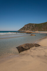 Lofoten beach view, with mountains and blue skies, in summer.