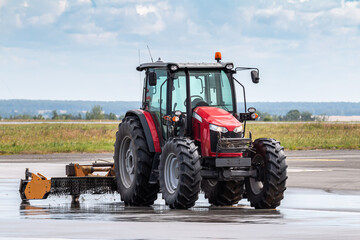 Wheel tractor with lawn mower on the road