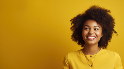 Obraz na płótnie Canvas young woman african smiling wearing yellow shirt on the yellow pastel background