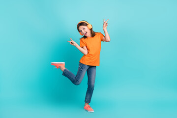 Photo of energetic crazy cute girl wear stylish orange clothes hand demonstrate v-sign good mood isolated on cyan color background