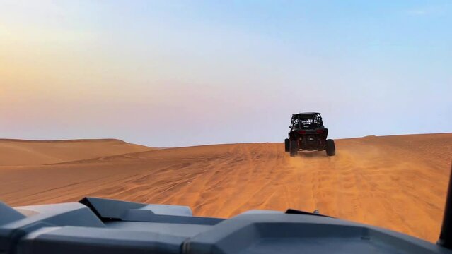 Riding buggies in the desert during sunset. High quality FullHD footage