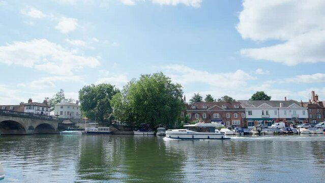 River Thames At Henley On Thames In Oxfordshire UK With Town Skyline And Pleasure Boat