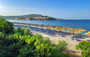 Beach and old town of Primosten, Croatia. Photographed in summer.