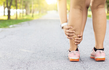 Injury from workout concept. Running sport injury leg pain. Runner woman massaging sore calf...