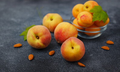 Harvest of peaches for food or juice. fresh organic fruit, vegan food. Large peaches on dark table background, selective focus.