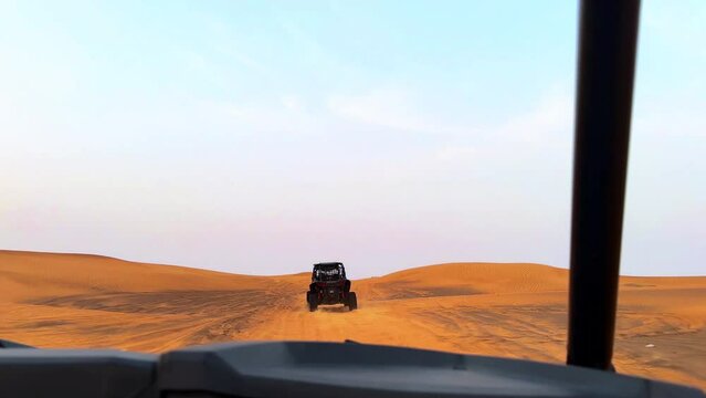 buggy in the desert at sunset