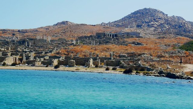 view from the sea of the ancient monuments and ruins on the sacred island of Delos, Greece. The birth place of god Apollo.