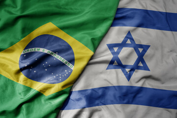 big waving realistic national colorful flag of brazil and national flag of israel .