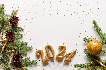 Happy new year frame. Christmas card banner with Christmas tree branches and gold candle numbers 2024, cones and golden decorative ribbon, golden stars. light background. mockup.