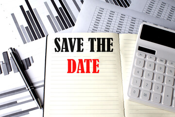 SAVE THE DATE text written on a notebook on chart and diagram