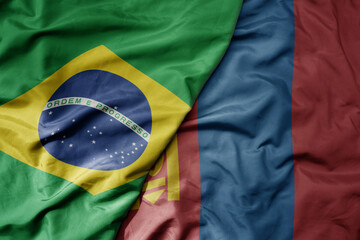 big waving realistic national colorful flag of brazil and national flag of mongolia .