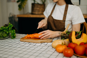Close up young woman hands preparing a healthy salad. Cutting vegetables tomatoes on a cutting board on the home .