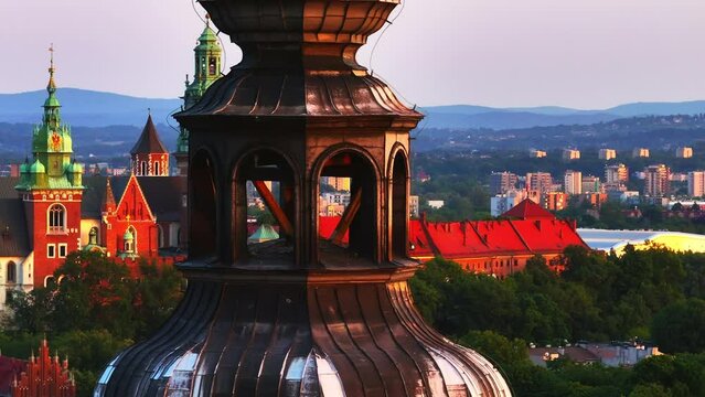 The town hall tower, and the royal castle on the Wawel Hill in the background. Poland, Krakow. Aerial shoots