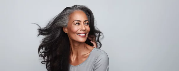 Foto auf Acrylglas Höhenskala Beautiful black woman with smooth healthy face skin. Gorgeous aging mature woman with long gray hair and happy smiling. Beauty and cosmetics skincare advertising concept.