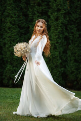 red-haired girl bride with a wedding bouquet