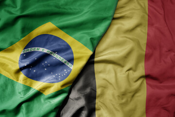 big waving realistic national colorful flag of brazil and national flag of belgium .