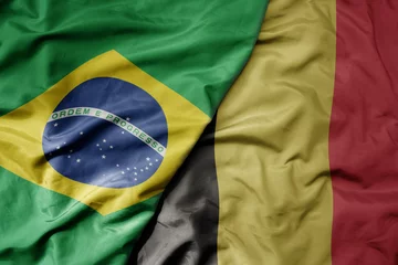 Papier Peint photo Brésil big waving realistic national colorful flag of brazil and national flag of belgium .