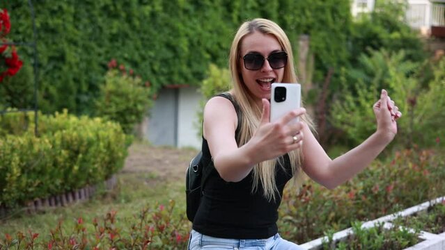 blonde woman taking selfies in the park video