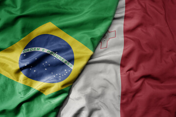 big waving realistic national colorful flag of brazil and national flag of malta .