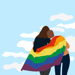 An embracing LGBT couple. A couple of girls in love covered with an LGBT community flag against the sky. The concept of a homosexual, a gay community, a tolerant LGBTQ society.