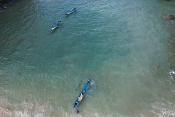 fishing boats anchored on the shore. Indonesia is the largest maritime country in the world that produces a lot of fish catches from the ocean. aerial view of shore. white sandy beach.  