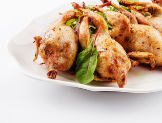 Tasty fried quail on white plate