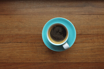 close up of a cup of coffee on wooden background                                                                                                                                                        