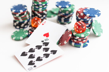 Poker game on green table with multi-color ships, cards and dices , isolated on white background.