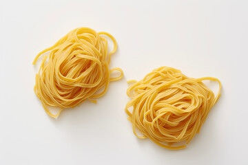 Fresh spaghetti, ready to be cooked, laid out on a white surface, italian pasta tagliatelle