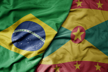 big waving realistic national colorful flag of brazil and national flag of grenada .