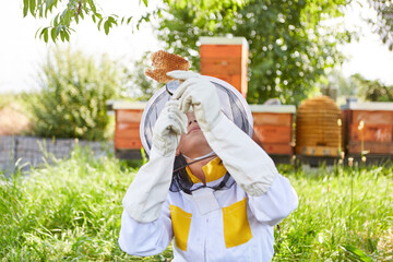 Girl learning to be beekeeper with magnifying glass
